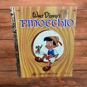 May include: A vintage "Walt Disney's Pinocchio" Little Golden Book. The cover features an illustration of Pinocchio as a puppet, with Jiminy Cricket. The book has a gold spine and a price tag of 59¢.