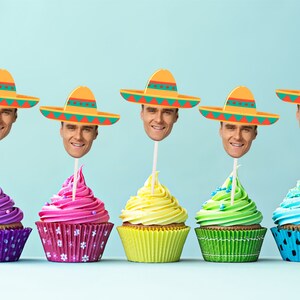 May include: Five cupcakes decorated with colorful frosting and topped with a paper sombrero with a face cutout. The cupcakes are arranged in a row on a light blue background.