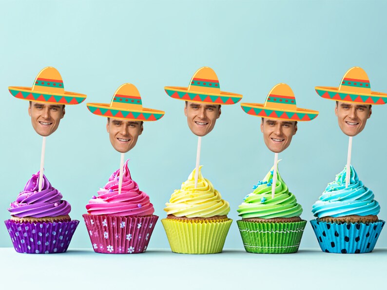 May include: Five cupcakes decorated with colorful frosting and topped with a paper sombrero with a face cutout. The cupcakes are arranged in a row on a light blue background.