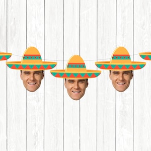 May include: A string of six colorful paper party decorations featuring a face wearing a sombrero. The sombreros are yellow, orange, and green with red accents. The faces are all the same and have a smiling expression.