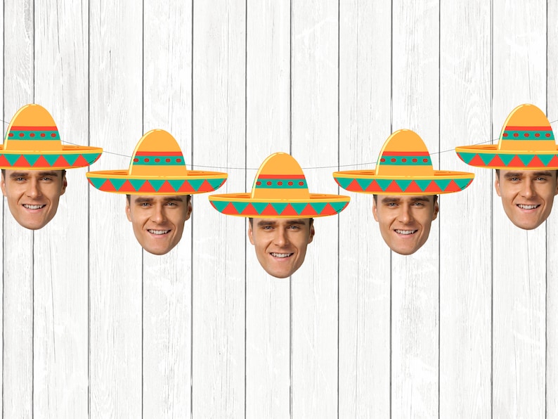 May include: A string of six colorful paper party decorations featuring a face wearing a sombrero. The sombreros are yellow, orange, and green with red accents. The faces are all the same and have a smiling expression.