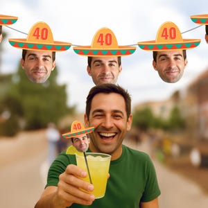 May include: A man holding a cocktail with a sombrero-themed decoration. The image features a festive garland of sombreros with the number "40" on them. The man is wearing a green shirt and smiling.