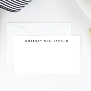 May include: A white card with a white envelope. The card has the text "WHITNEY WILLIAMSON" printed in black at the top.