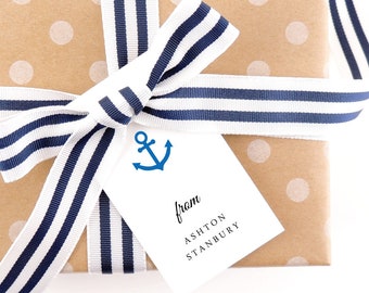 May include: A brown gift box with white polka dots wrapped in blue and white striped ribbon. A white gift tag with a blue anchor and the text "from Ashton Stanbury" is attached to the ribbon.