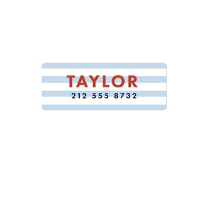 May include: A blue and white striped label with the name "TAYLOR" in red text and the phone number "212 555 8732" in blue text.