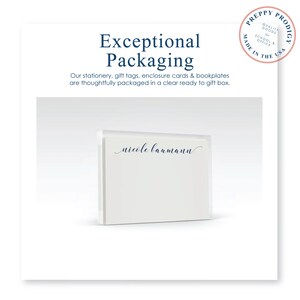 May include: A white box with a clear front panel, showing a stack of personalized stationery with the name "nicole baumann" printed in blue ink. The box is sitting on a white surface. The text "Exceptional Packaging" is printed above the box.