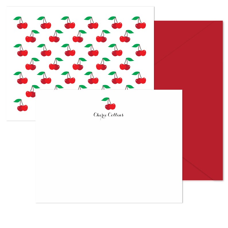 May include: A white card with a red cherry pattern and a white envelope with a single red cherry and the name "Cherie Collins" printed on it.