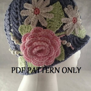 May include: Crochet hat pattern featuring a blue hat with pink and white flowers. The pattern is for a crocheted hat with flowers. PDF pattern only.