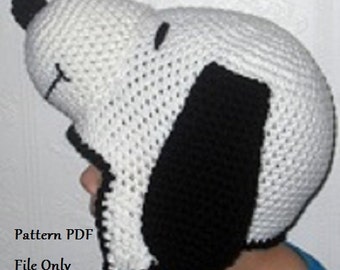 May include: A white and black crocheted hat shaped like a cartoon dog. The hat has a black nose and ears. The text "Pattern PDF File Only" is visible at the bottom of the image.