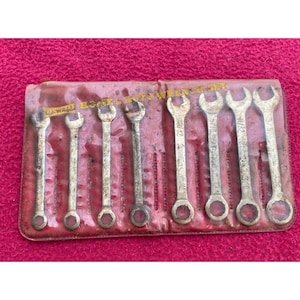May include: A set of eight wrench tools in a red plastic package. The wrenches are silver and have black markings. The package says "DXWALL HOME & AUTO WRENCH SET".