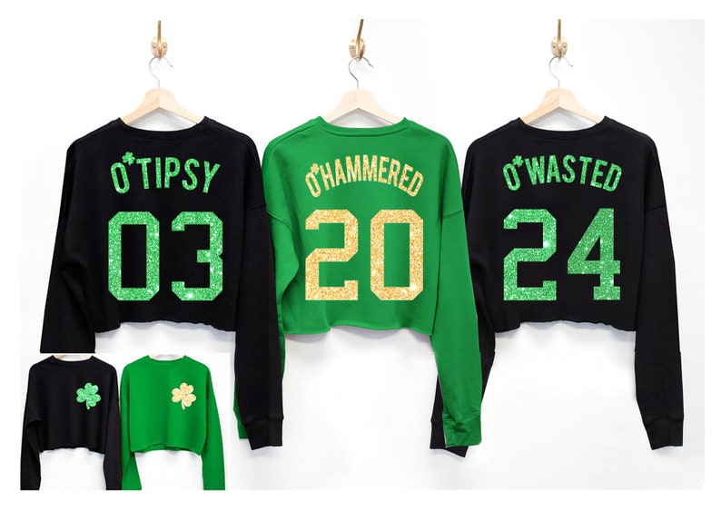 May include: Three black and green cropped sweatshirts with glitter text and numbers on the back. The sweatshirts say "O'Tipsy 03", "O'Hammered 20", and "O'Wasted 24".