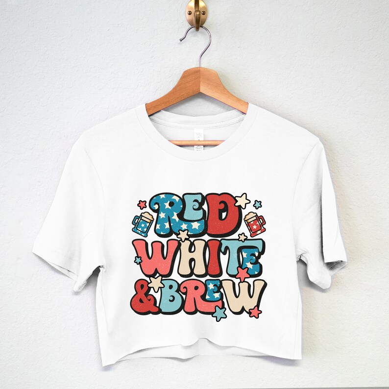 May include: White cropped t-shirt with a red, white, and blue graphic that says "Red White & Brew" with stars and beer mugs.