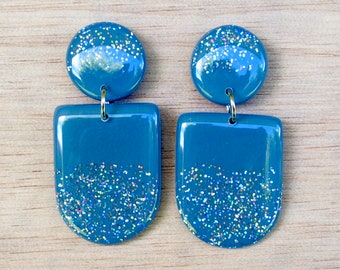 Free shipping within Australia! Handmade teal blue polymer clay stud dangle earrings with silver glitter and a resin finish