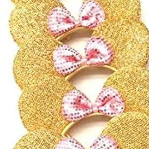 May include: Several gold sequined mouse ear headbands with pink and white polka dot bows. The ears are round and glittery, and the headbands are a thin gold color. The bows are centered on the headband.