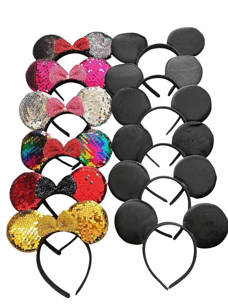 May include: A collection of headbands with sequined ears and bows in various colors, including black, pink, silver, and gold. Some headbands feature solid black ears. The bows are red, pink, and black.