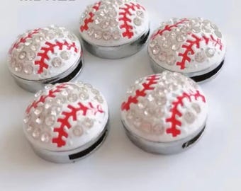 May include: Five white baseball charms with red stitching and rhinestones. The charms are silver-toned and have a flat back.