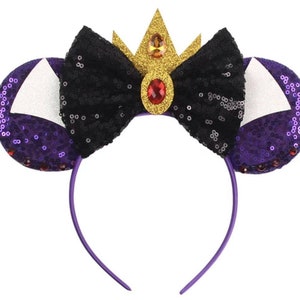 May include: Purple and black sequined headband with a black bow and a gold crown with a red jewel.