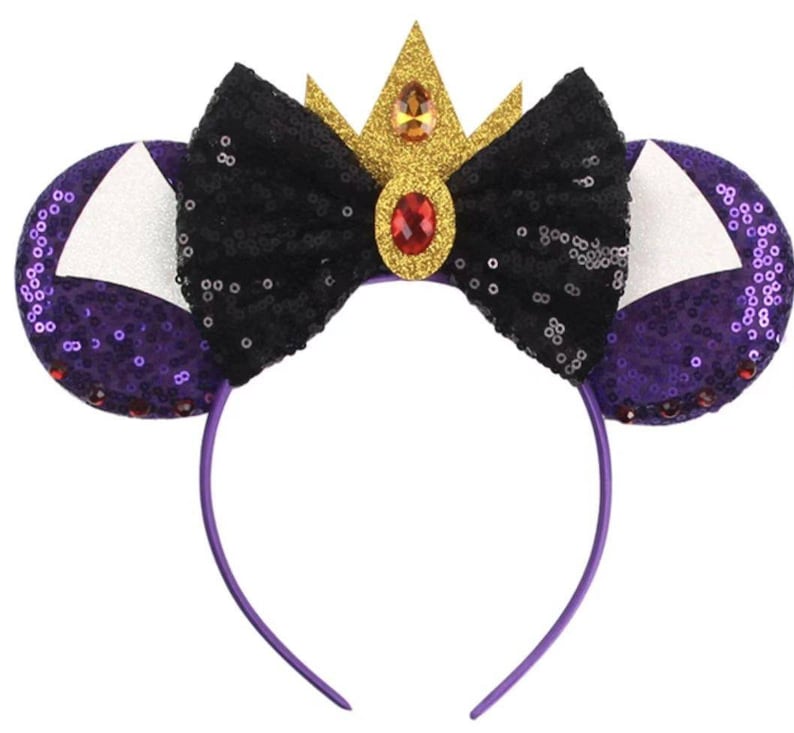 May include: Purple and black sequined headband with a black bow and a gold crown with a red jewel.