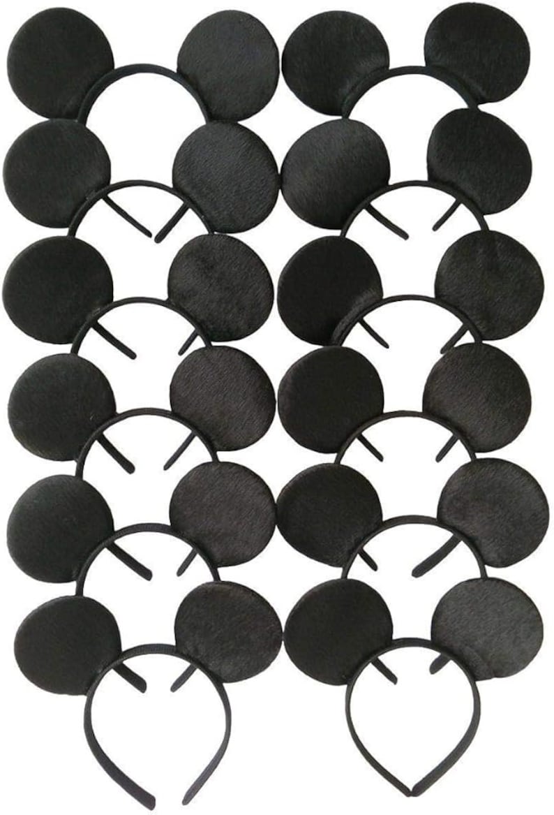 May include: A collection of black mouse ear headbands. Each headband features two large, round, black ears attached to a black plastic headband. The ears have a textured appearance. The headbands are arranged in a grid pattern.