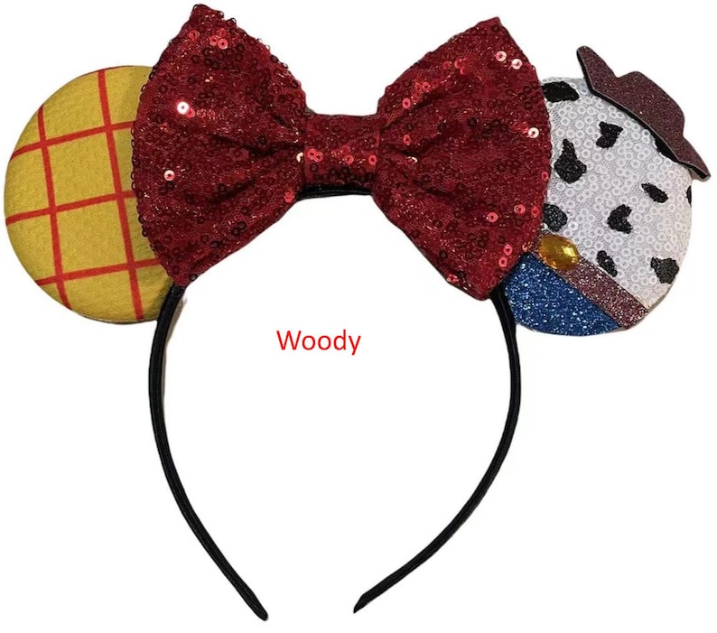 May include: Red sequined bow headband with a yellow and red checkered fabric ear and a white, black, and blue fabric ear with a sheriff's star. The headband says "Woody".