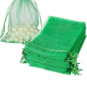 May include: A stack of 25 green organza gift bags with a drawstring closure. The bags are made of sheer fabric and are perfect for small gifts or favors.