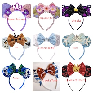 May include: Nine pairs of character-themed mouse ears with headbands. The ears are decorated with various characters, including Rapunzel, Ursula, Olaf, Cinderella, Elsa, Avatar, Ahsoka Tano, and the Queen of Hearts.