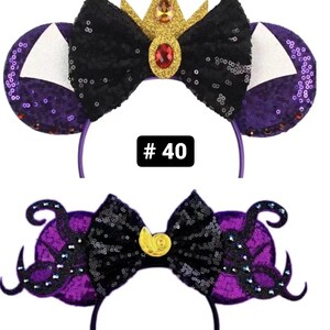 May include: Two pairs of purple and black sequined Minnie Mouse ears with a bow. The first pair has a gold crown with a red jewel on top of the bow. The second pair has a gold seashell on top of the bow. The ears are numbered #40 and #41.
