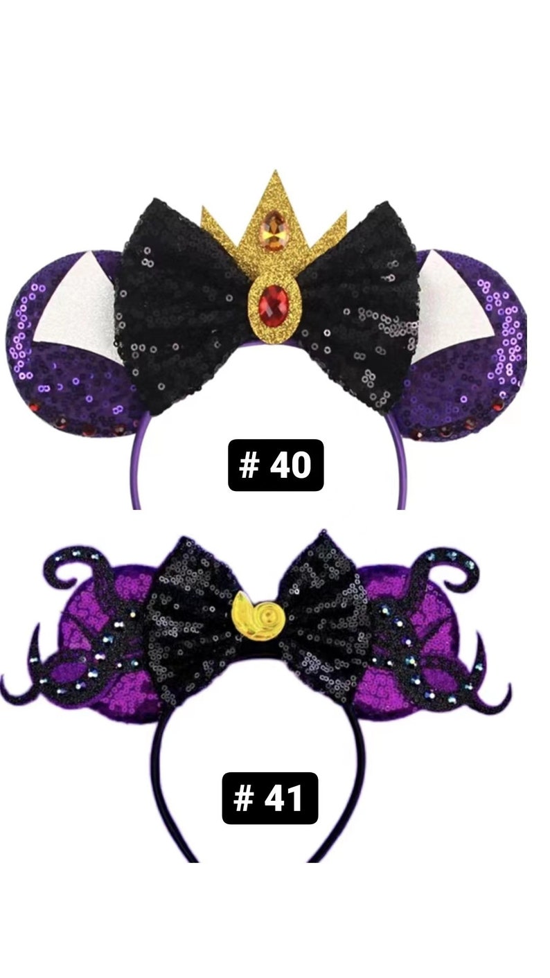 May include: Two pairs of purple and black sequined Minnie Mouse ears with a bow. The first pair has a gold crown with a red jewel on top of the bow. The second pair has a gold seashell on top of the bow. The ears are numbered #40 and #41.