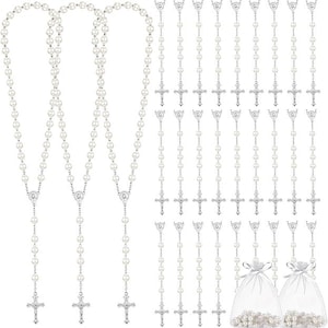 May include: A collection of rosaries featuring faux pearl beads and silver-toned crucifixes. The image includes several long rosary necklaces and individual rosary strands, some packaged in small, sheer drawstring bags. The rosaries are a religious item.