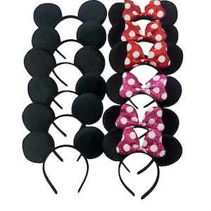 May include: A collection of twelve headbands arranged in two columns. The left column features six plain black ear headbands. The right column features six black ear headbands, each adorned with a sequined bow in red, pink, or magenta with white polka dots.