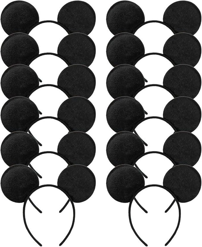 May include: A collection of black mouse ear headbands. Each headband features two round, black ears attached to a thin, black plastic band. The ears are made of a soft, felt-like material. The headbands are arranged in neat rows.