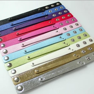 May include: A set of 12 leather bracelets with silver studs. The bracelets are in various colors, including black, blue, purple, red, pink, light pink, light blue, green, white, gold, and silver.