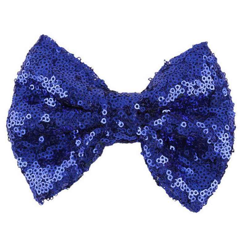 May include: A large blue bow made of sequins. The bow is tied in a knot in the center and has a shiny, sparkly finish.