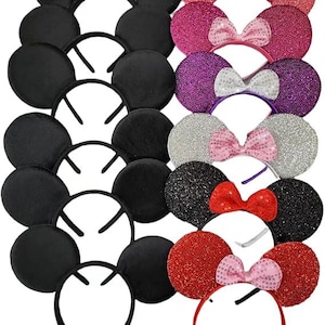 May include: A collection of mouse ear headbands in various colors. Some are solid black, while others feature glitter in pink, purple, silver, black, and red. Each headband has a matching bow.