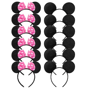 May include: A collection of black mouse ear headbands, some with pink bows featuring white polka dots. The ears are round and made of a soft material. The headbands are black and curved.