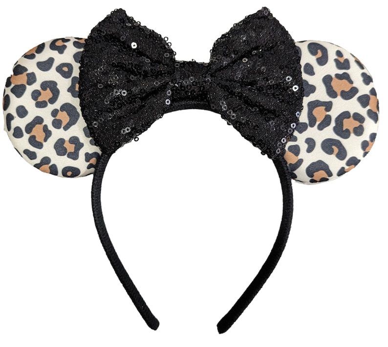 May include: Leopard print mouse ears headband with a black sequined bow.