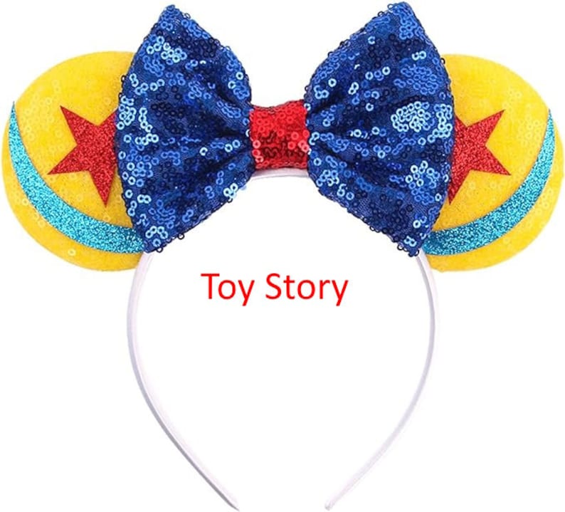 May include: Blue and yellow sequined headband with a red bow and a white headband. The headband features a yellow and blue star design. The text "Toy Story" is printed on the headband.
