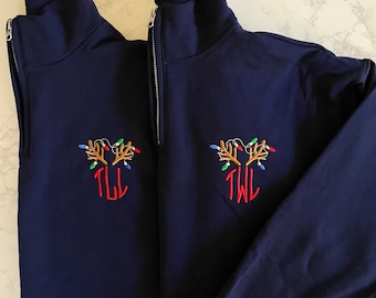 May include: Two navy blue quarter-zip sweatshirts with embroidered reindeer antlers and Christmas lights. The left sweatshirt has the monogram "TLL" and the right sweatshirt has the monogram "TWL".
