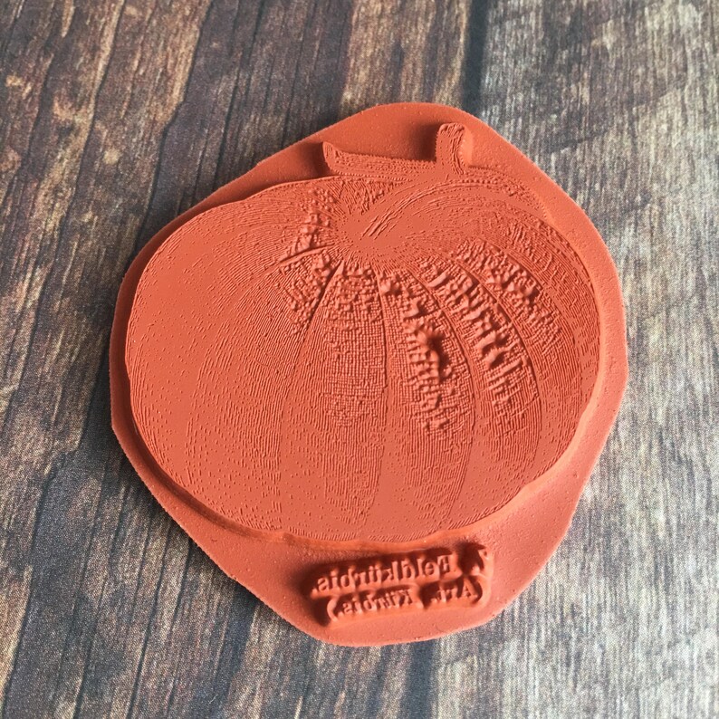May include: A red rubber stamp with a detailed image of a pumpkin. The stamp is labeled "Red Pumpkin (c)Lori Art".