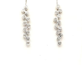 18kt white gold long diamond earrings.