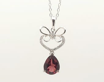 18kt white gold diamond and pear shaped Garnet pendant.