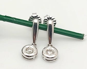 14kt white gold bezel set diamond earrings.