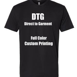 May include: Black t-shirt with white text that reads "DTG Direct to Garment Full Color Custom Printing." The shirt is a crew neck style and appears to be made of a soft material.