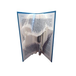 May include: A hardback book with blue covers and white pages, folded to create a three-dimensional sculpture. The pages are intricately folded to form a shape, showcasing the art of book folding.