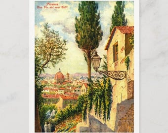 Könnte beinhalten: Eine Vintage-Postkarte, die eine Straßenszene in Florenz, Italien, zeigt. Die Postkarte zeigt einen Blick auf die Stadt mit dem Dom in der Ferne, eine von Bäumen gesäumte Straße und ein Gebäude mit einem Fenster und einer Straßenlaterne. Der Text auf der Postkarte lautet "Firenze Una Via dei suoi Colli".