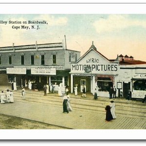 May include: Vintage postcard featuring a street scene in Cape May, N.J. The image shows a trolley station, shops, and a movie theater with the text "Lyric Motion Pictures." People in period clothing are walking on the boardwalk.