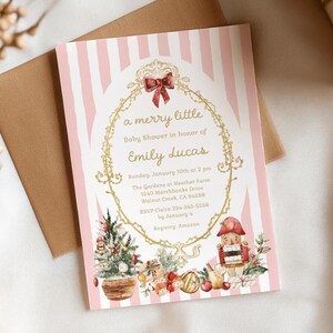 May include: A rectangular baby shower invitation card featuring a light pink and white vertical striped background. The centre displays a gold ornate frame with a red bow, enclosing text details for Emily Lucas. Below are illustrations of a Christmas tree, gifts, and a nutcracker.