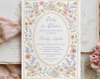Könnte beinhalten: Eine rechteckige Einladungskarte für eine Babyparty mit einem zentralen ovalen Rahmen, der von einer bunten Blumenbordüre umgeben ist. Der Text lautet: Baby in Bloom, join us for a baby shower in honor of Emily Lucas, Saturday, March 9th at 3 PM.