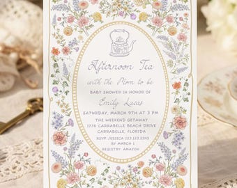 May include: A rectangular invitation card for an Afternoon Tea baby shower in honor of Emily Lucas. The card features a central oval frame with a teapot illustration, surrounded by a colorful floral border of pink, yellow, and blue flowers.