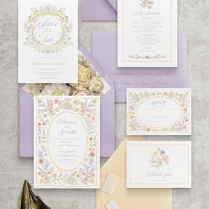 May include: A collection of wedding stationery, including invitations, RSVP cards, and thank you notes. The designs feature floral borders and elegant fonts. The color palette includes soft pastels, lavender envelopes, and a ring box.